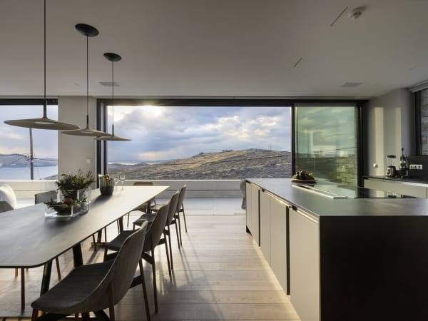 The panoramic open-concept living and dining area in the main house.
